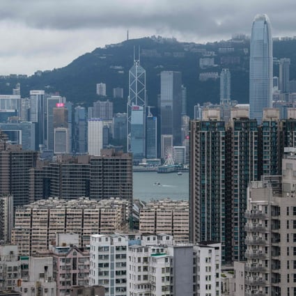 A general view of residential and commercial buildings in the Kowloon district (foreground) with the skyline of Hong Kong Island past Victoria Harbour (C) in the distance on August 3, 2019. Photo: AFP