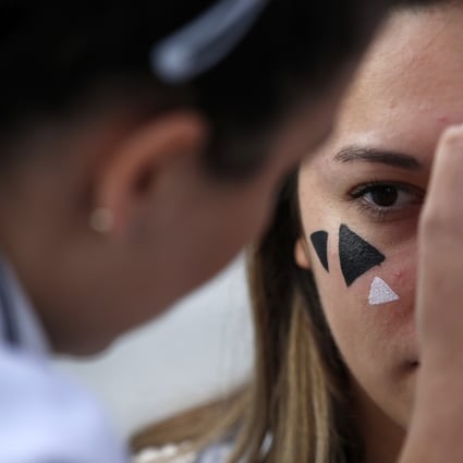Members of a rights group use paint to confuse the Huawei surveillance video cameras featuring facial recognition software in Belgrade, Serbia, on September 25. With public authorities disclosing little about how the cameras work, the group set up a tent to ask pedestrians whether they knew they were being watched. Photo: AP