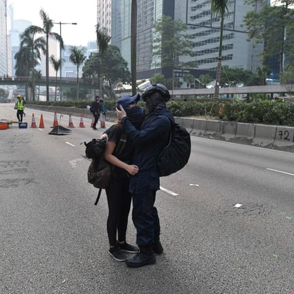 A tender moment between protesters in the middle of a blocked road following an unsanctioned march through Hong Kong on September 29. Photo: AFP