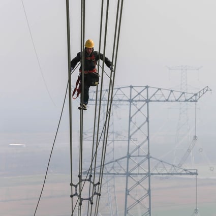 A technician examines the transmission line on an ultra-high voltage system in Huaian, Jiangsu province, in 2015. State Grid’s internet technologies project is another part of its plan to upgrade China’s power infrastructure. Photo: Xinhua