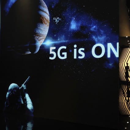 A guide is silhouetted in an exhibition promoting Huawei's 5G technologies in Shenzhen, China. Photo: AP