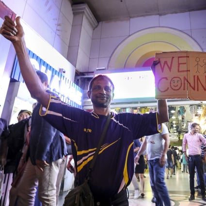 Hongkongers join a sing-along with protesters outside the cultural melting pot of Chungking Mansions. Photo: Dickson Lee