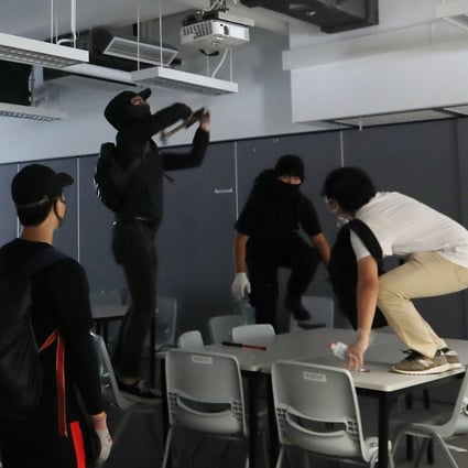 Masked students vandalise classrooms at the Hong Kong Design Institute. Photo: Xiaomei Chen