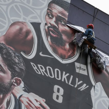 The National Basketball Association’s (NBA) China marketing plan was upended after the Houston Rockets’ general manager tweeted a message supporting Hong Kong protesters. Pictured is an NBA promotional banner being removed in Shanghai on October 9. Photo: AFP