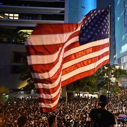 A man waves a US flag as protesters attend a rally in Central, Hong Kong, on October 14, calling on US politicians to pass a bill that could alter Washington’s relationship with the trading hub. Photo: AFP