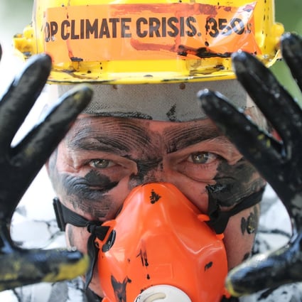 An environmental activist in Rio de Janeiro protests against plans to auction off oil blocks near the coast of Brazil on Tuesday. Photo: Reuters