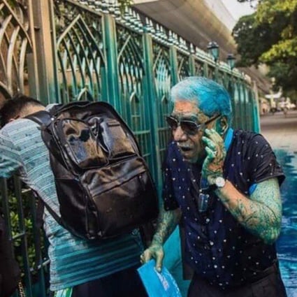 People outside Kowloon Mosque are covered in blue dye fired from a police water cannon during a protest in Hong Kong’s Tsim Sha Tsui district. Photo: Twitter