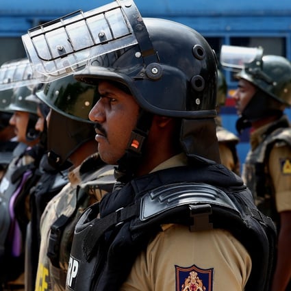 Indian security personnel stand guard outside a mosque in Bangalore on the day of the Supreme Court ruling. Photo: EPA