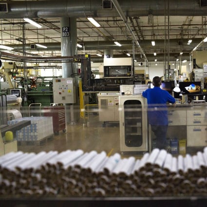 Cigarettes moves along a machine during the assembly process at the Philip Morris International’s Coltabaco facility in Medellin, Colombia. Photo: Bloomberg