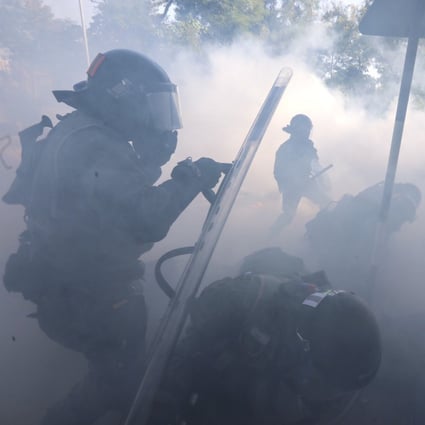 Riot police fire tear gas and make arrests as anti-government protesters set up roadblocks outside Chinese University of Hong Kong in Sha Tin early on Monday. Photo: Felix Wong