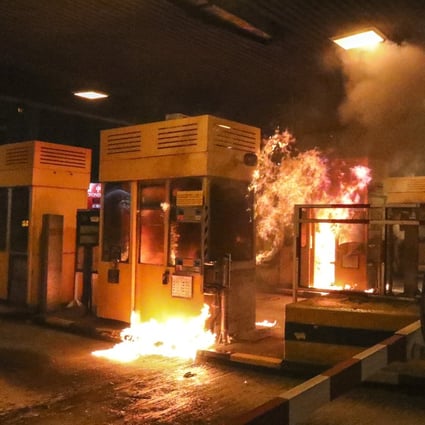 Protesters set tollbooths at the Cross-Harbour Tunnel on fire. Photo: Felix Wong