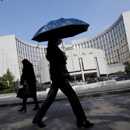 People walk past the headquarters of the People's Bank of China (PBOC), the central bank, in Beijing, China. Photo: Reuters