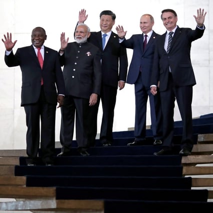 President of South Africa Cyril Ramaphosa, India’s Prime Minister Narendra Modi, President Xi Jinping of China, Russia’s President Vladimir Putin and President Jair Bolsonaro of Brazil pose for a family photo as they arrive for the BRICS summit. Photo: Reuters