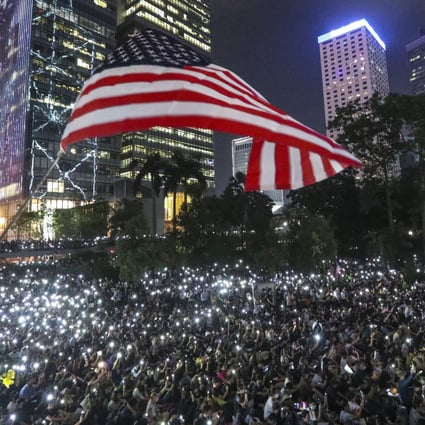 Anti-government protesters wave a US flag during a demonstration at Chater Garden in Central. Photo: Felix Wong