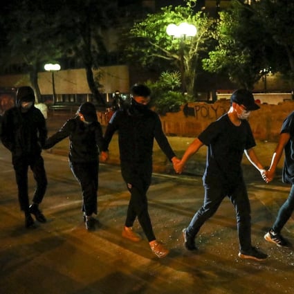 Protesters surrender to police outside the Hong Kong Polytechnic University on Friday. Photo: Sam Tsang