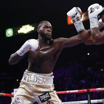 Deontay Wilder throws a left hand against Luis Ortiz in their heavyweight title match. Photo: AP