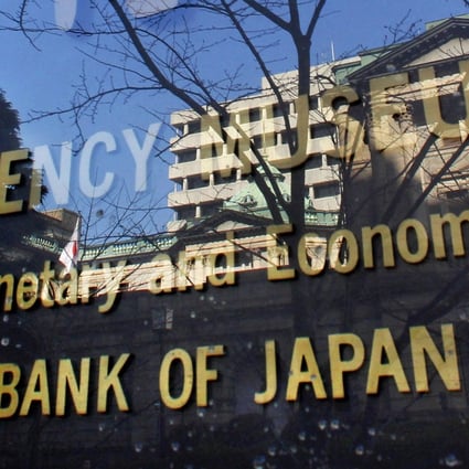 The Bank of Japan, reflected in the glass wall of its adjunct museum in Tokyo. Historically low to negative interest rates have forced Japanese investors to seek returns outside Japan. Photo: AP