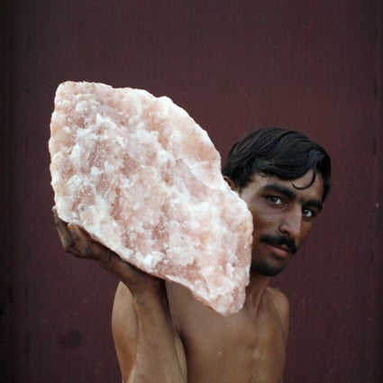 A labourer carries rock salt at Khewra, Pakistan. Pink salt has become a political issue in Pakistan, after a story on social media that India has been re-exporting the salt worldwide and labelling it “made in India”. Photo: Reuters