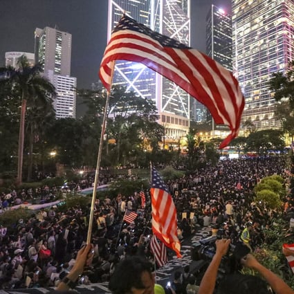 Anti-government protesters wave US flags during a demonstration in Central in October to urge the US Congress to pass the Hong Kong Human Rights and Democracy Act. Photo: Felix Wong