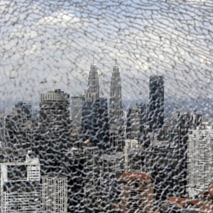 The Kuala Lumpur skyline, as seen through a cracked glass pane. Photo: Bloomberg