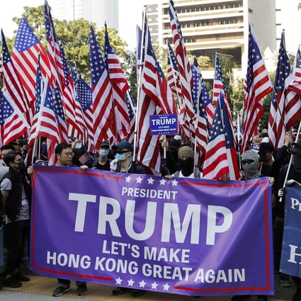 Rallyists wave American flags as they march to US Consulate to thank President Donald Trump. Photo: AP