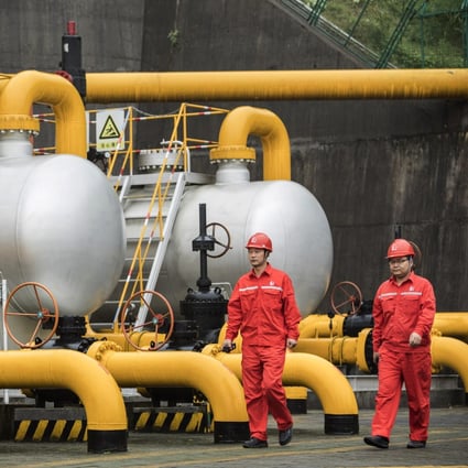 China needs to involve state-owned and private companies in policy making to better address major global problems like climate change. Here, workers walk past pipework and storage tanks at a project operated by Sinopec Chongqing Fuling Shale Gas Exploration and Development a unit of China Petrochemical Corp. Photo: Bloomberg