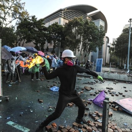 A protester throws a petrol bomb at police near Polytechnic University in Hung Hom on November 17. Photo: Felix Wong
