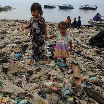 Children on a heavily polluted beach in Bali, Indonesia. A team of Hong Kong students has invented a cheap robot that can collect plastic from the sea and reduced the scourge of marine pollution. Photo: Riau Images/Barcroft Images via Getty Images
