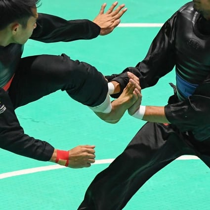 Action from the Pencak Silat at the Asian Games 2018 between Komang Harik Adi Putra (left) of Indonesia and Malaysia’s Mohd Al-Jufferi Jamari. Photo: Xinhua
