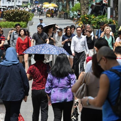 Pedestrians cross the street on Orchard Road in Singapore. Photo: AFP