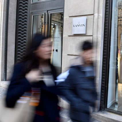 Pedestrians walk past a Lanvin shop on the Rue du Faubourg Saint-Honore in Paris. Fosun bought the ailing French fashion label with a promise to revive its fortunes. Photo: AFP