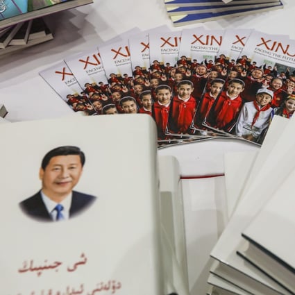Books by Chinese President Xi Jinping in the Uygur language, left, and Kazakh language, right, are displayed at an official press conference on the issues of “building a beautiful Xinjiang, jointly realising the Chinese dream”, in Beijing on July 30. Photo: Simon Song