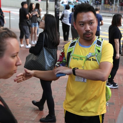Protest Tour guide Michael Tsang Chi-fai (centre) takes tourists Sarah Severance (L) from US and Andrew Jones (R) from UK, around the protest areas, Tin Hau. 02NOV19 SCMP / Xiaomei Chen