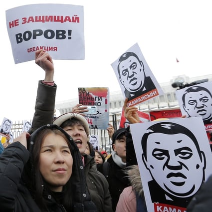 People hold up placards reading “Do not protect thieves”, during an anti-corruption rally in Bishkek, Kyrgyzstan, in November. Photo: EPA-EFE