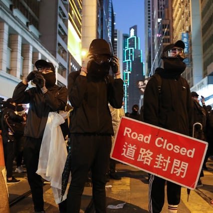 Black-clad protesters occupy a section of Des Voeux Road in Central on December 8, engaging in a standoff with riot police that continued into the evening. Photo: Winson Wong