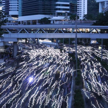 Hong Kong protesters used their smartphones to create a streaming flow of light in the streets. Photo: Sam Tsang