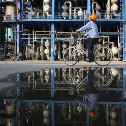 An engineer on a bicycle checking pipelines at an oil refinery of China National Petroleum Corp (CNPC), in Lanzhou, Gansu province on April 21, 2008. Photo: Reuters