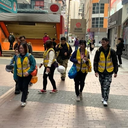 Seven members of ‘Protect the children’, a group of adult and elderly volunteers in yellow vests who usually stand on the front line to urge restraint from police during clashes, fail to find any protesters in Mong Kok. Photo: Victor Ting