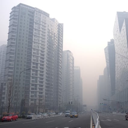 Cars drive past high-rise buildings in the haze of the central business district in Beijing. British companies say life is getting tougher for them in China. Photo: AFP
