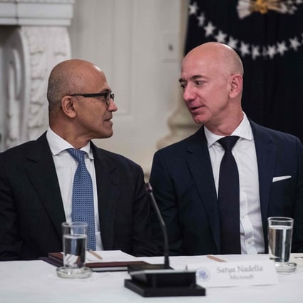 Microsoft CEO Satya Nadella (L) and Amazon CEO Jeff Bezos chat during an American Technology Council roundtable at the White House in Washington, DC, on June 19, 2017. Photo: AFP