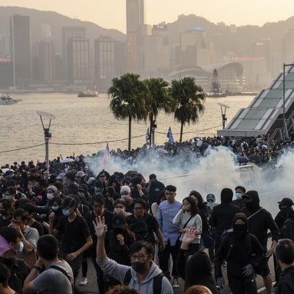 Riot police fire tear gas to disperse demonstrators during a protest in Tsim Sha Tsui on December 1. Photo: Bloomberg