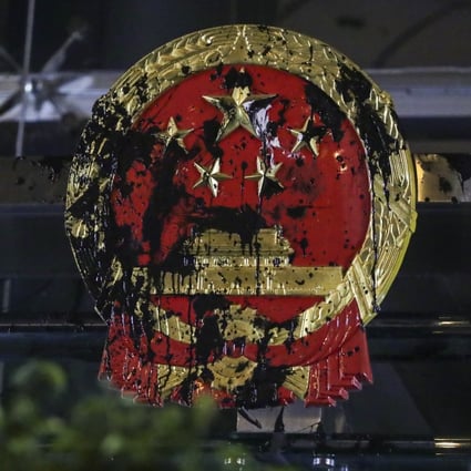The Chinese national emblem outside Beijing’s liaison office in Hong Kong was vandalised on July 21 during a march organised by the Civil Human Rights Front against the now withdrawn extradition bill. The incident triggered Chinese media to end its silence on the Hong Kong protests. Photo: Edmond So
