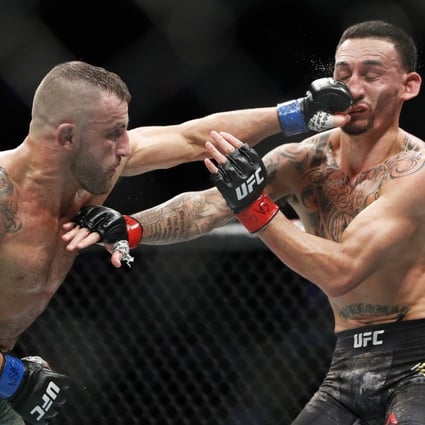 Alexander Volkanovski hits Max Holloway in their featherweight championship bout at UFC 245. Photo: AP