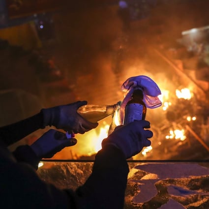 Protesters prepare a petrol bomb during clashes with police at the Polytechnic University campus in November. Photo: Sam Tsang