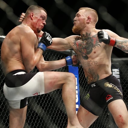 Conor McGregor (right) trades punches with Nate Diaz during UFC 196. Photo: AP