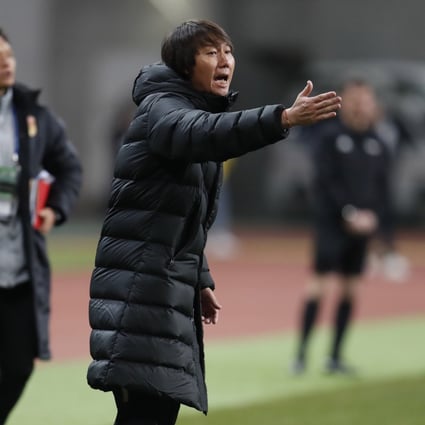 Li Tie shouts instructions to his players while in charge of China during the EAFF E-1 Championship match against South Korea. Photo: EPA