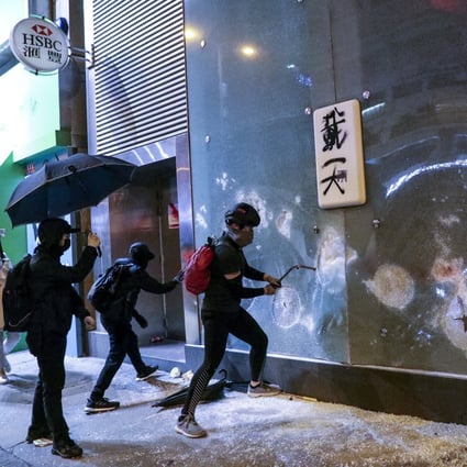 An HSBC branch is vandalised by protesters in Mong Kok on Christmas Day. HSBC became a target after Hong Kong police froze crowdfunded capital from a corporate account held by Spark Alliance HK, a non-profit organisation set up in 2016 to help protesters. Photo: May Tse