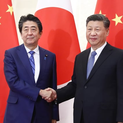 Japanese Prime Minister Shinzo Abe shakes hand with Chinese President Xi Jinping. Xi’s planned spring visit to Japan provides an opportunity to contain mutual hostility and expand relations. Photo: DPA