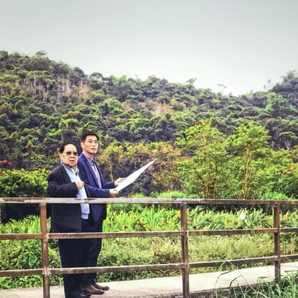 Wheelock Properties chairman Stewart Leung, left, and managing director Ricky Wong overlooking a site in Tai Po, one of three plots it will loan to NGOs for the use of temporary housing. Photo: SCMP Pictures