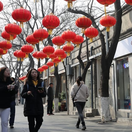 Tourists walk at Nanluoguxiang in Beijing. Nanluoguxiang has been developed into Beijing's busiest commercialised hutong. Photo: